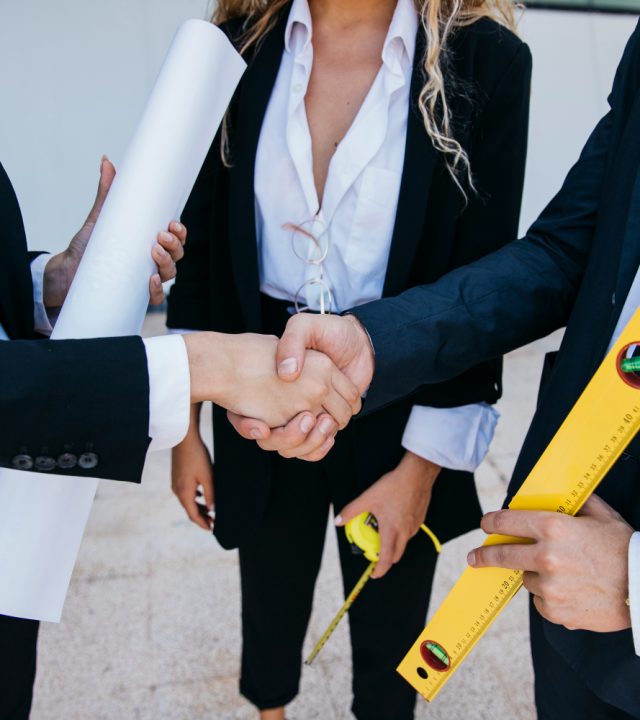 businessman-with-level-businesswoman-shaking-hands